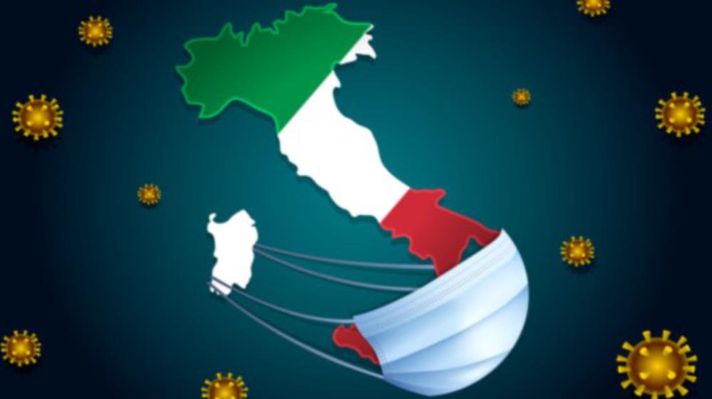 Graphic of the map of Italy as a boot in green, white and red, a breathing mask below, Covid viruses in the background.