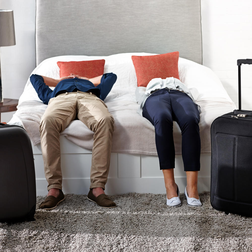Couple in a hotel room with luggage