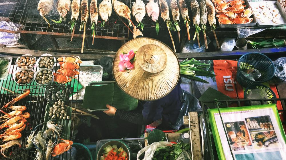 Asian marketplace. Women at her market stand for fish and seafood