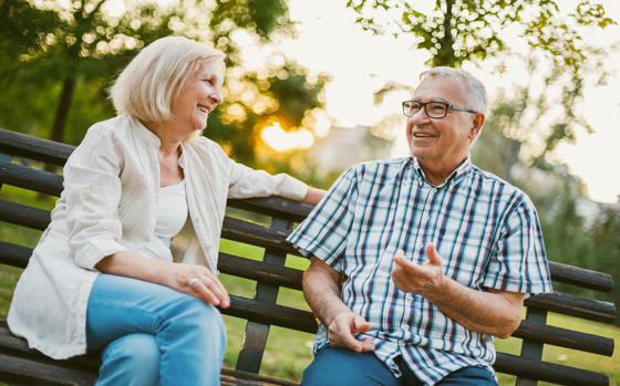 Seniors chatting on a bench in the park